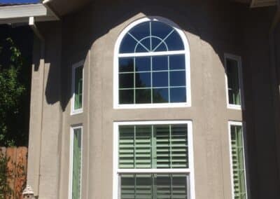 residential window replacement on stucco home exterior